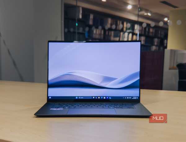 ASUS Zenbook S 16 on wooden table.