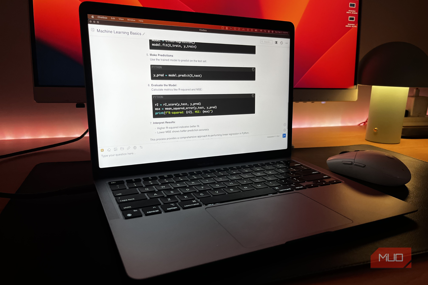 A MacBook Air running DeepSeek-R1 locally with a monitor in the background