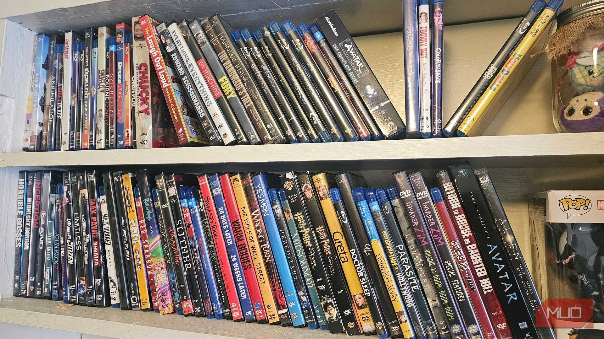 Two shelves with rows of DVDs and Blu-rays