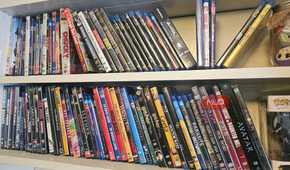 Two shelves with rows of DVDs and Blu-rays