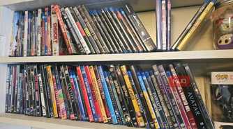 Two shelves with rows of DVDs and Blu-rays