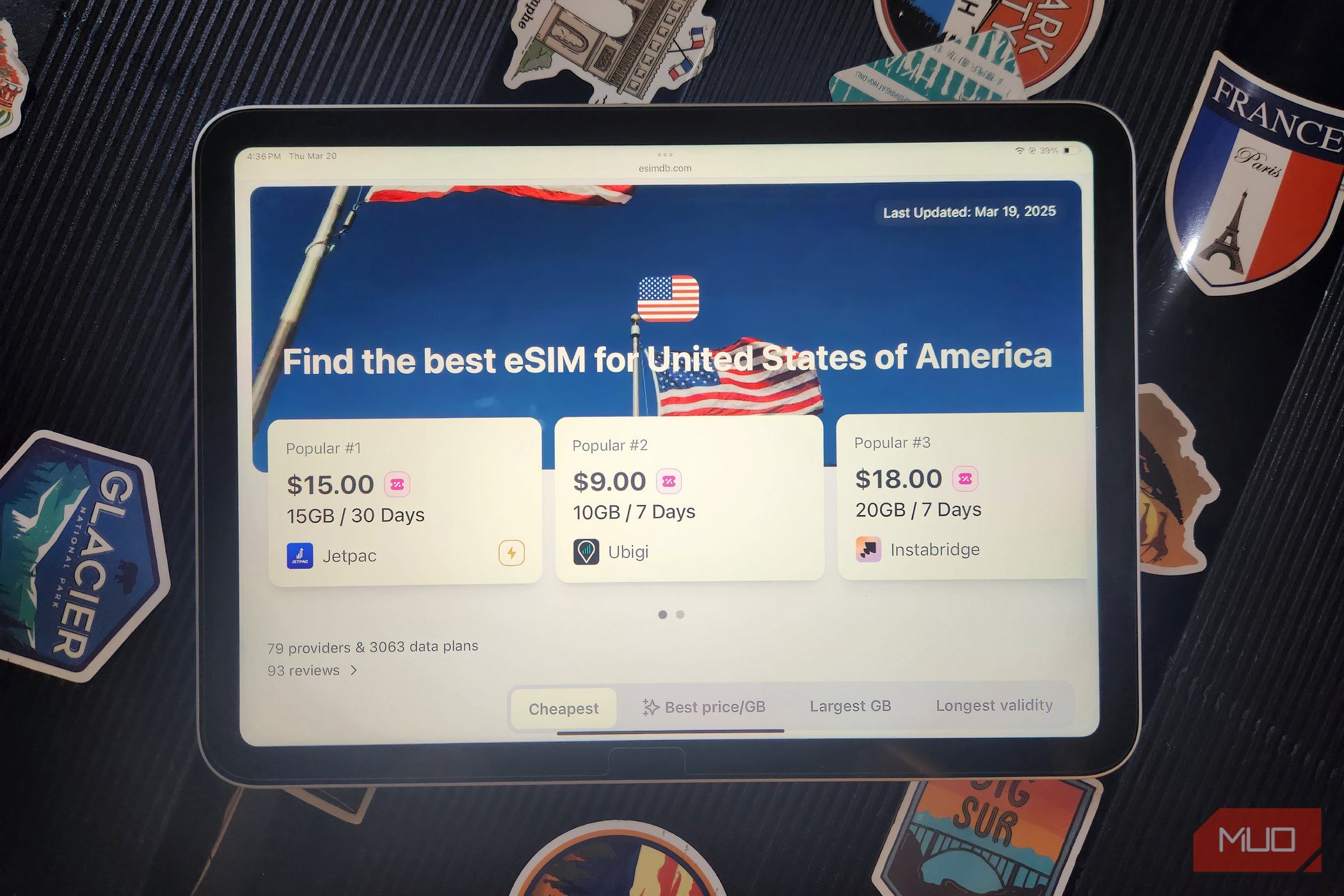 eSIM Website on and iPad with a suitcase.