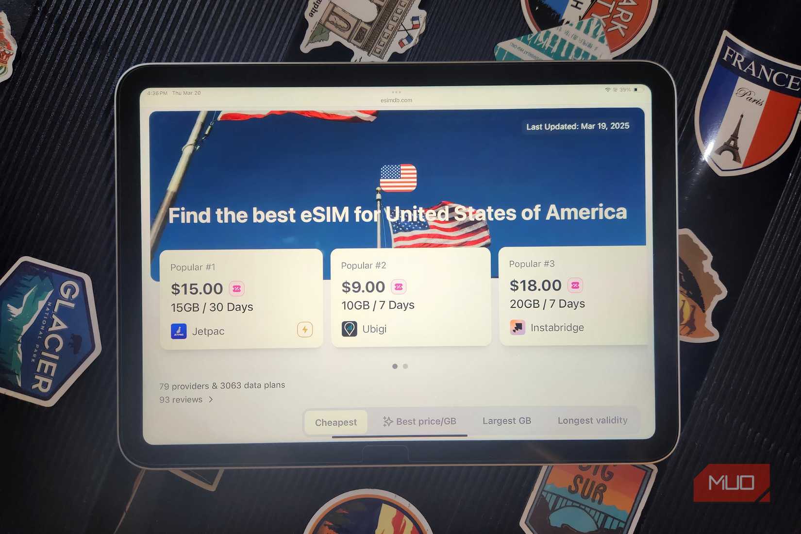 eSIM Website on and iPad with a suitcase.