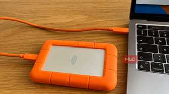 An External Hard Drive Plugged Into a Computer.