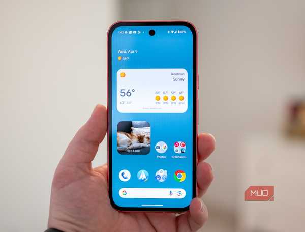 Person holding the Google Pixel 9a showing the home screen.