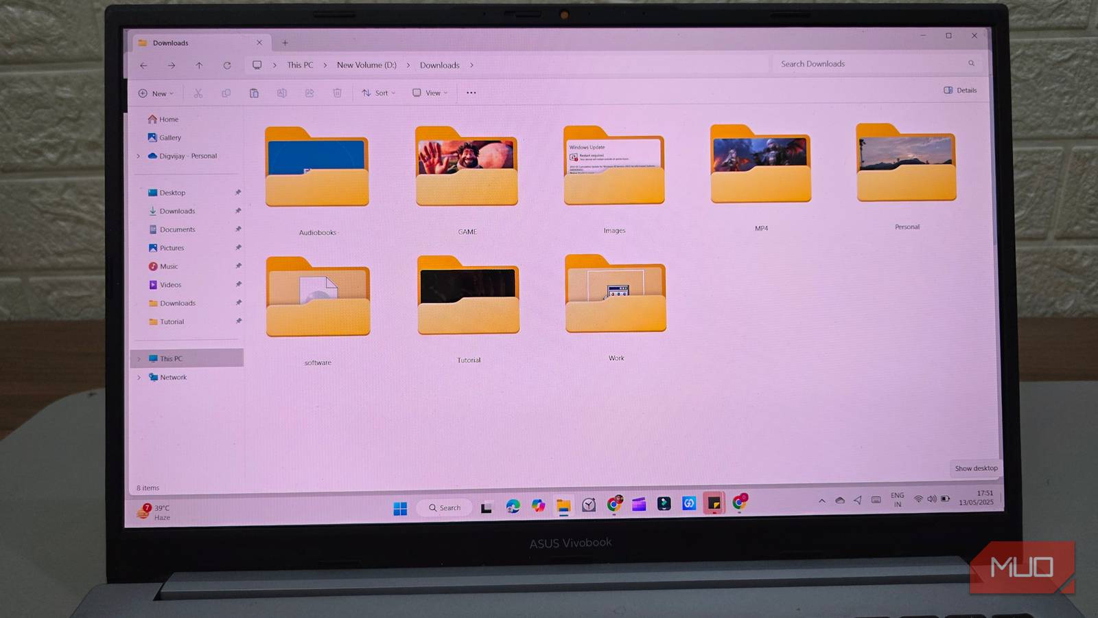 A laptop sitting on a desk displays an open file explorer window