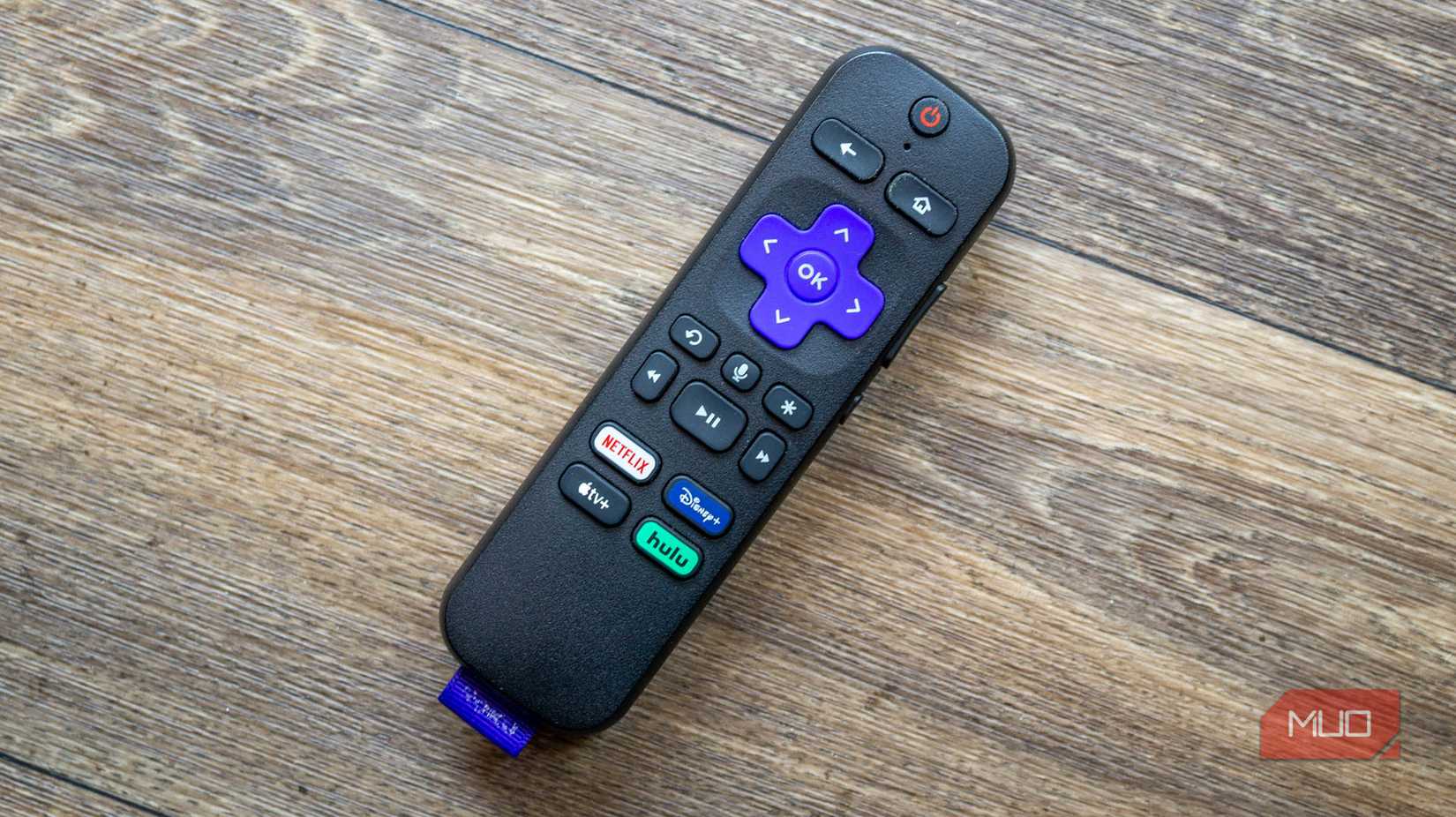 A Roku remote on a wooden table