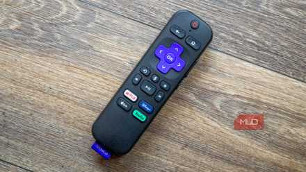 A Roku remote on a wooden table