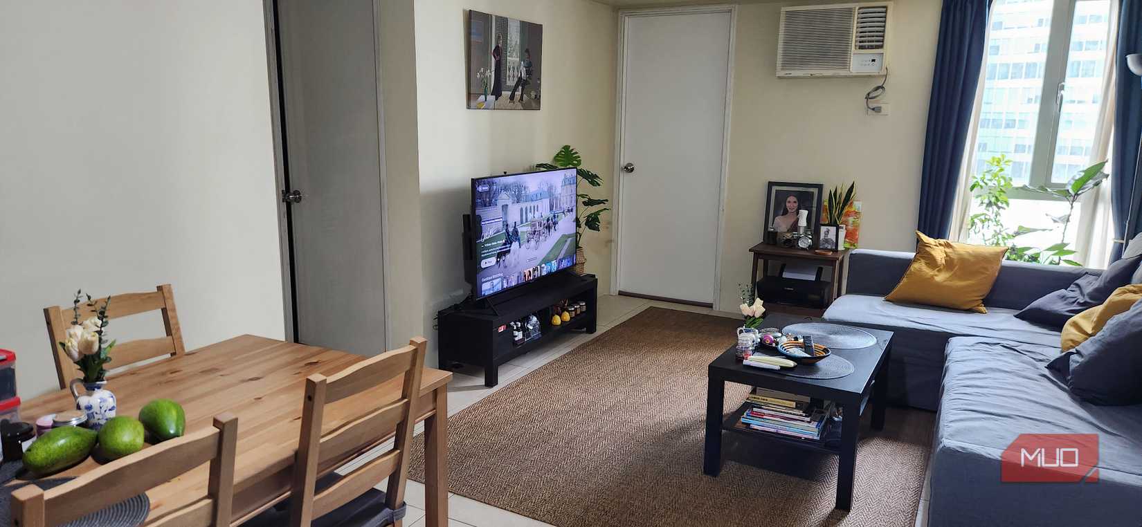 An open-plan living room with TV in the corner.
