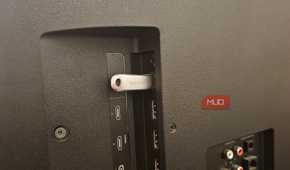 A SanDisk USB stick plugged into a Vizio smart TV's USB port
