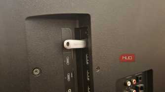 A SanDisk USB stick plugged into a Vizio smart TV's USB port