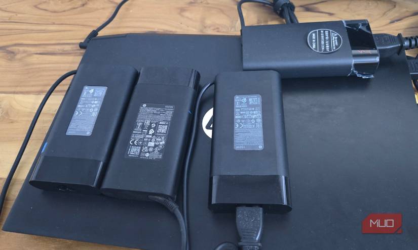 four Hp 150W charger placed on a HP laptop