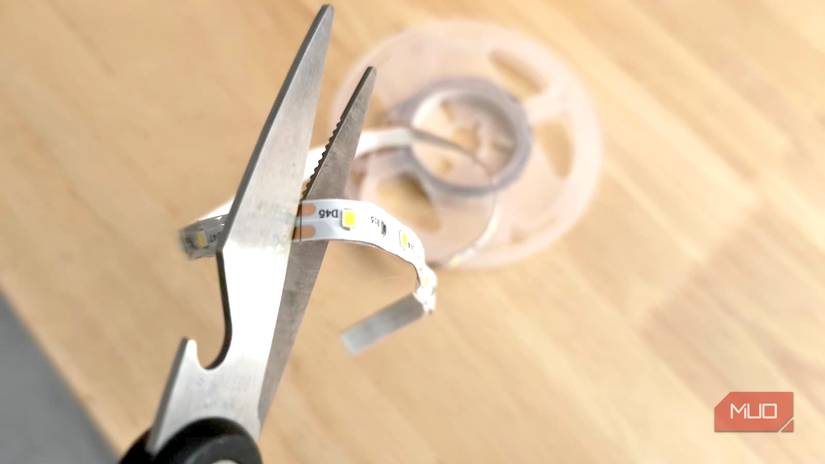 A pair of scissors ready to cut an LED strip