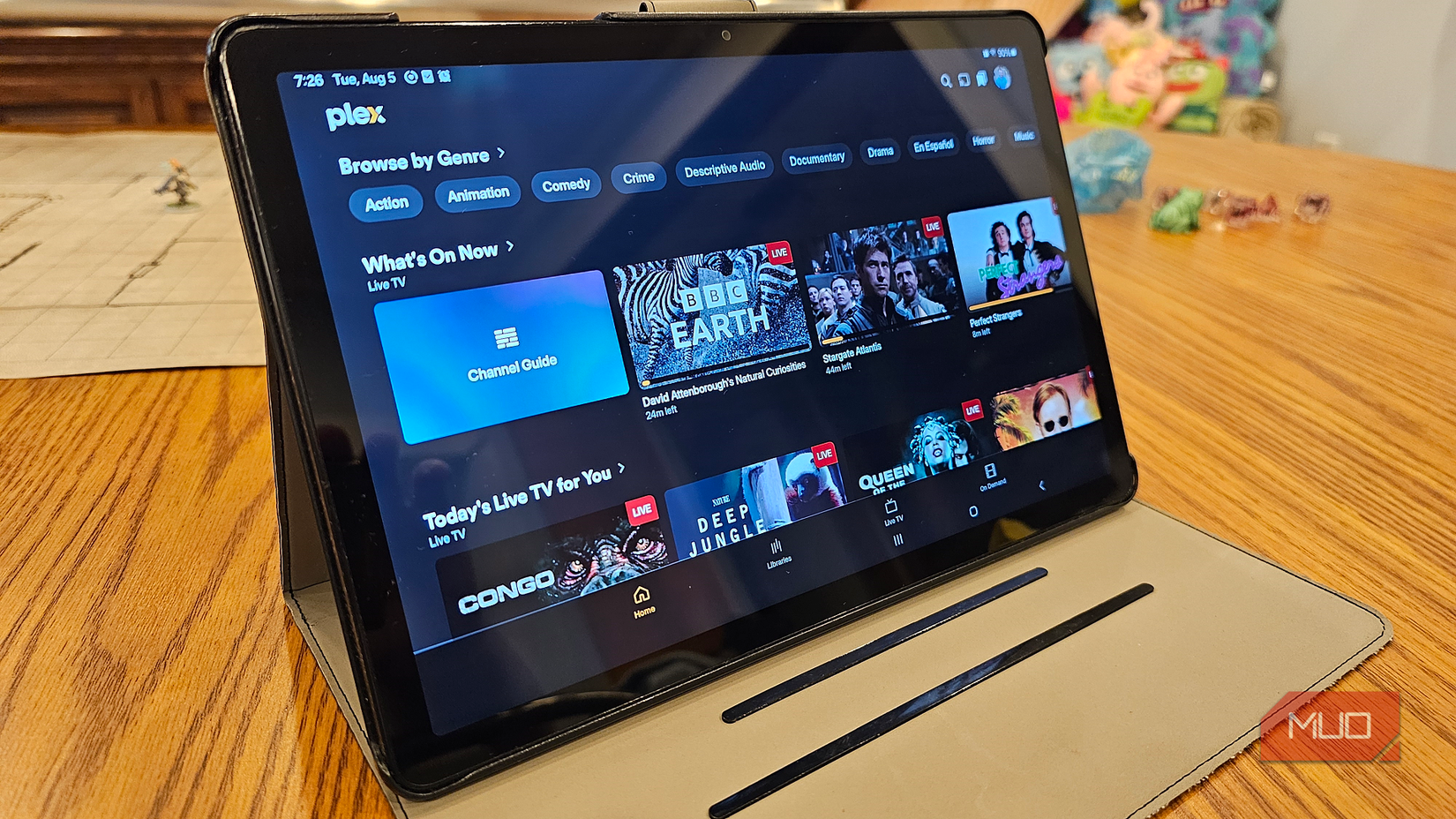 A Samsung tablet opened to the Plex app, with rows of live TV channels available to watch