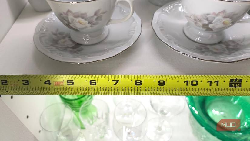 A tape measure measuring the length of a shelf