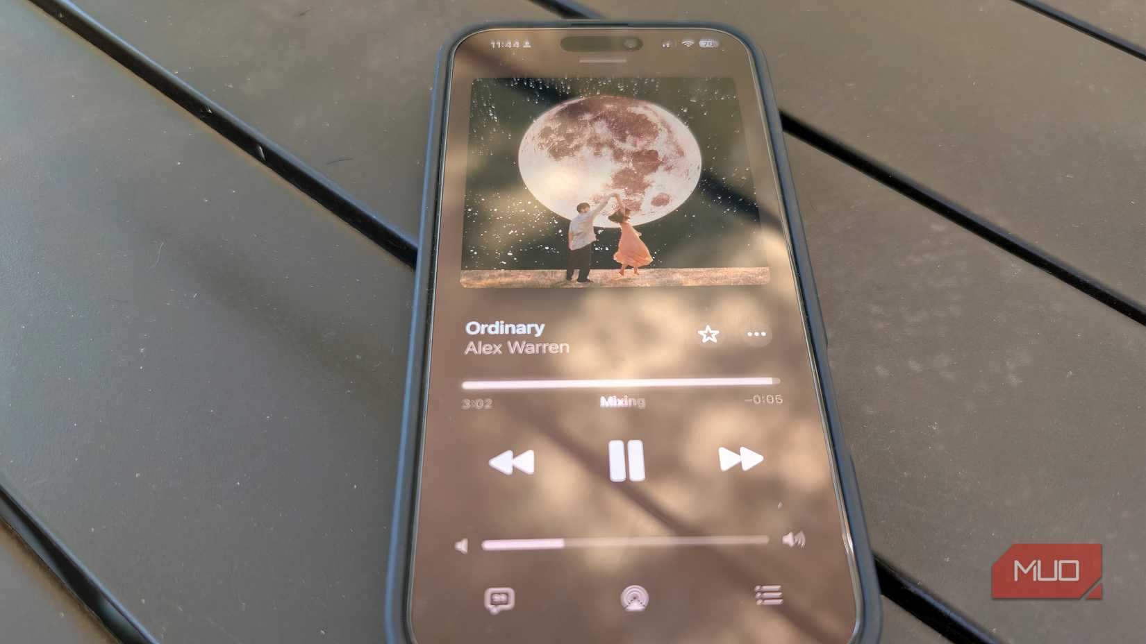 An iPhone on a table showing the Apple Music AutoMix feature. 