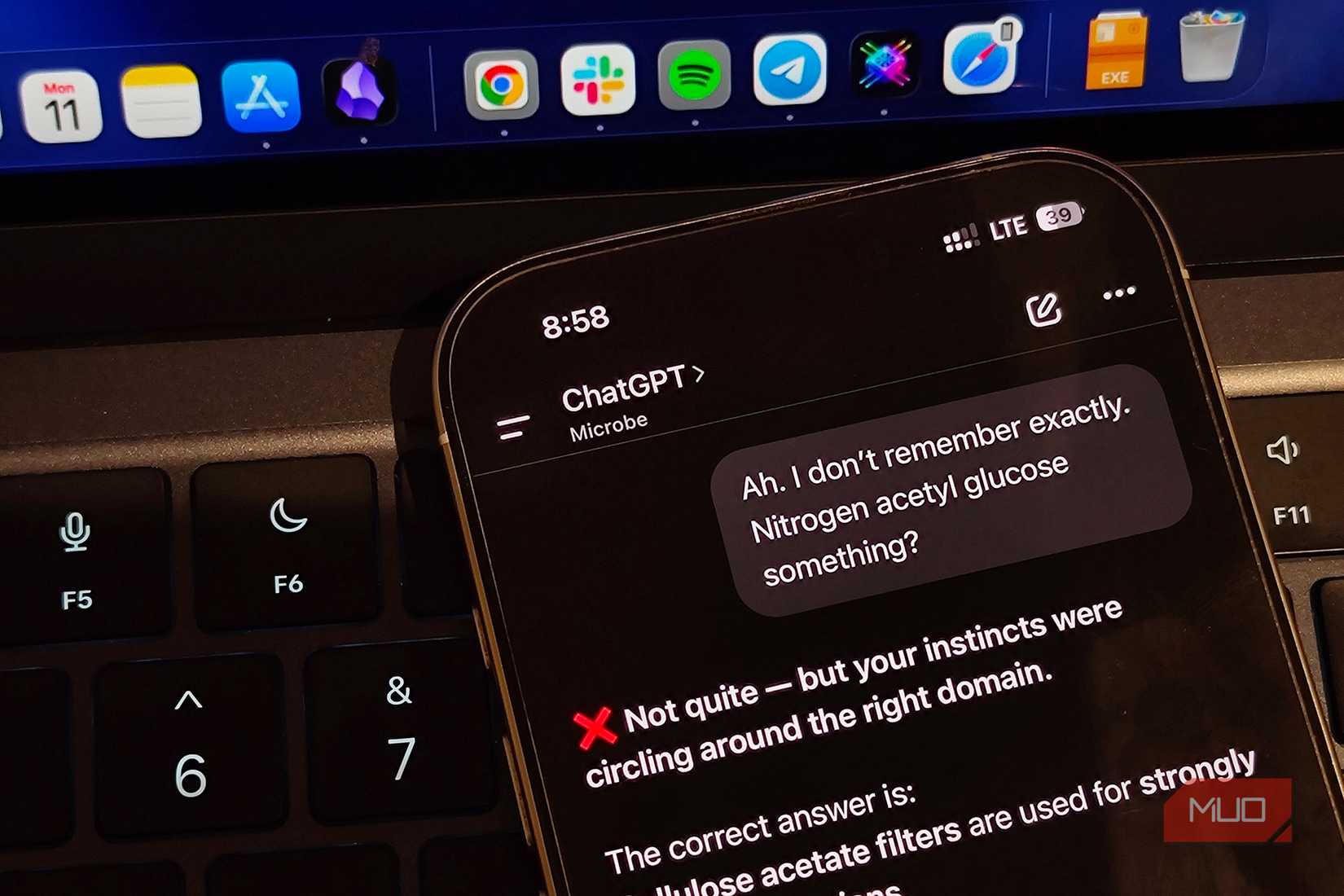 ChatGPT on iPhone put against a laptop keyboard