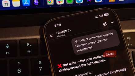 ChatGPT on iPhone put against a laptop keyboard