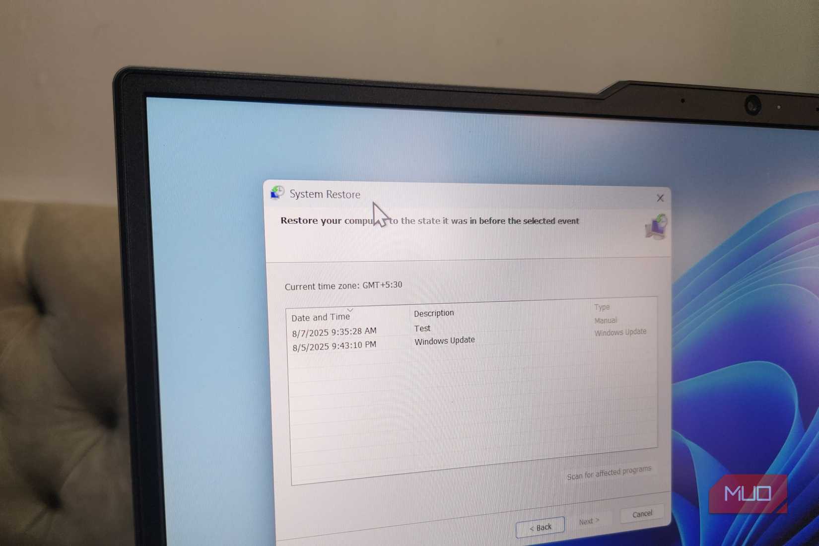 Close up of laptop showing System Restore window