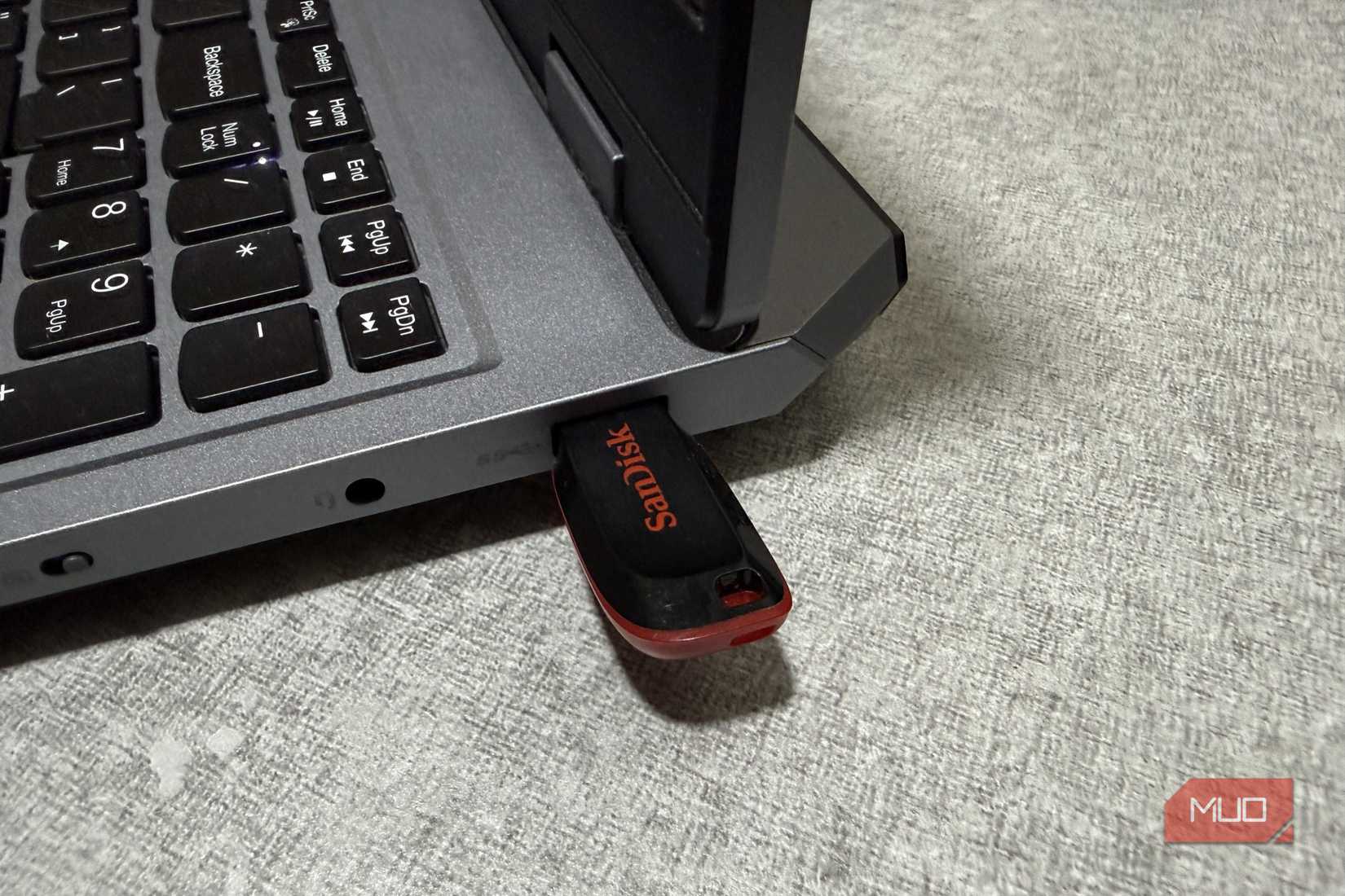 Close up of USB drive connected to a laptop