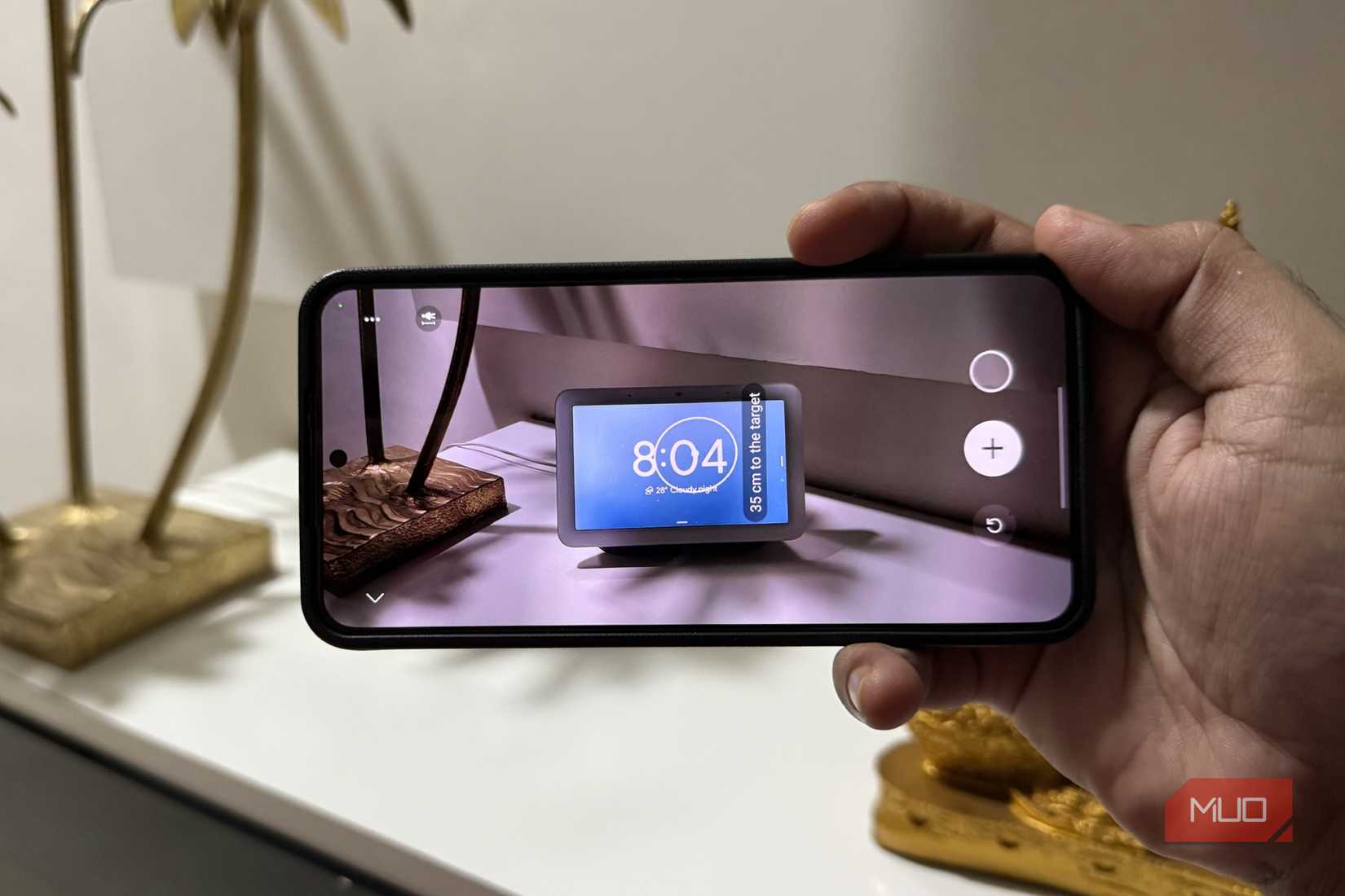 Samsung phone in hand with measurement app open