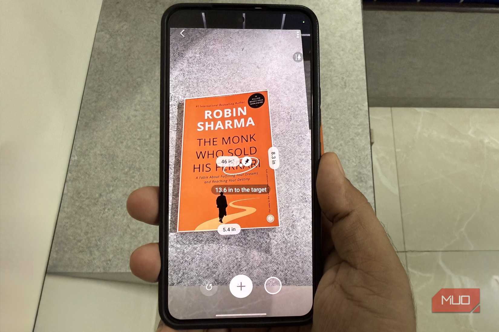 Samsung phone showing Quick Measure app measuring a book
