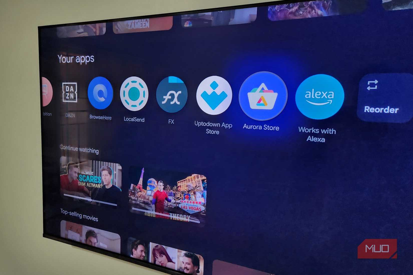 TCL Google TV on wall showing apps on home screen