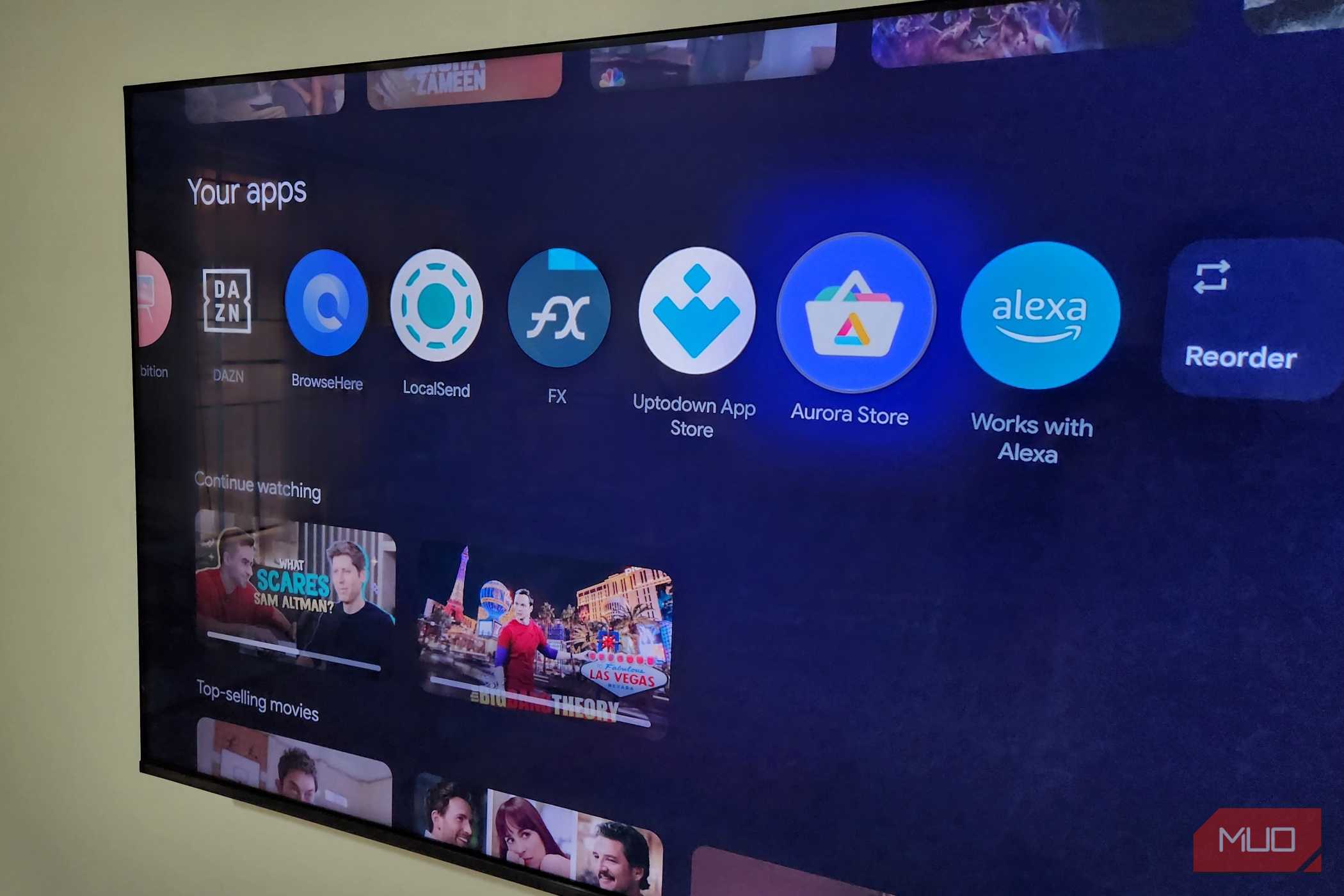 TCL Google TV on wall showing apps on home screen