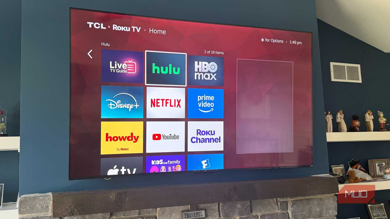 75 inch roku tcl smart tv mounted on blue wall