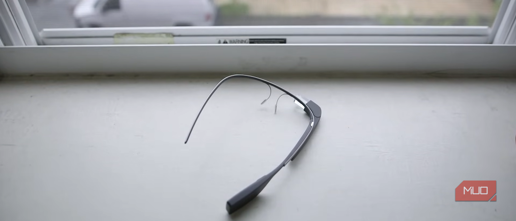 A Google Glass lying on a windowsill.