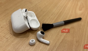 Airpods pro on table with a cleaning brush.