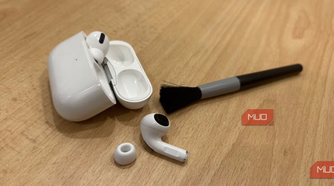 Airpods pro on table with a cleaning brush.