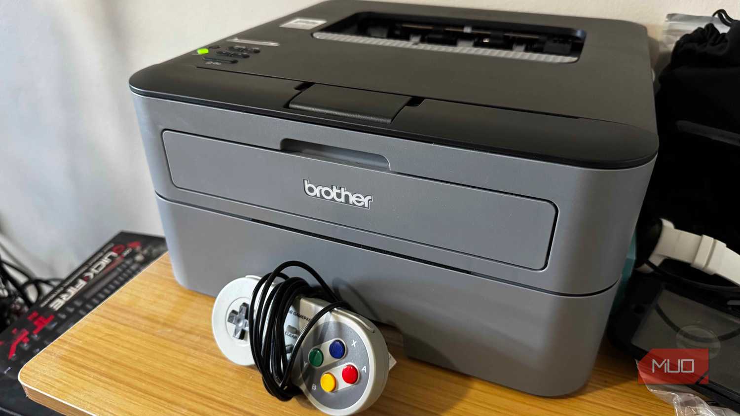 Brother Printer on a desk with an SNES controller in front