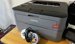 Brother Printer on a desk with an SNES controller in front