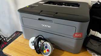 Brother Printer on a desk with an SNES controller in front