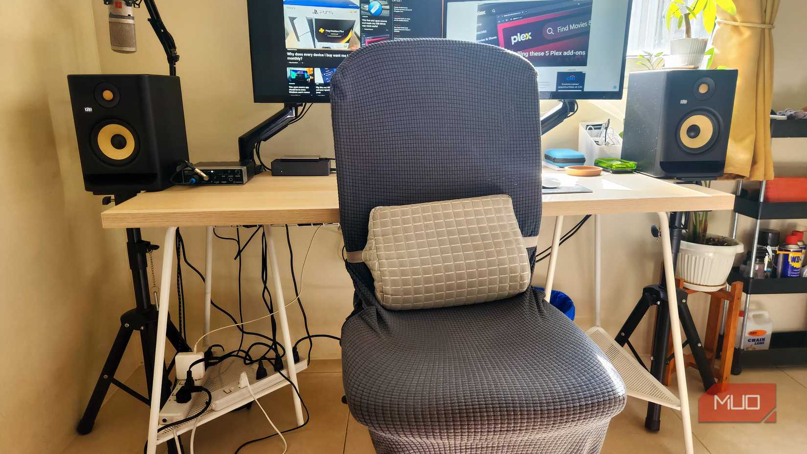 An office chair with an additional lumbar cushion.