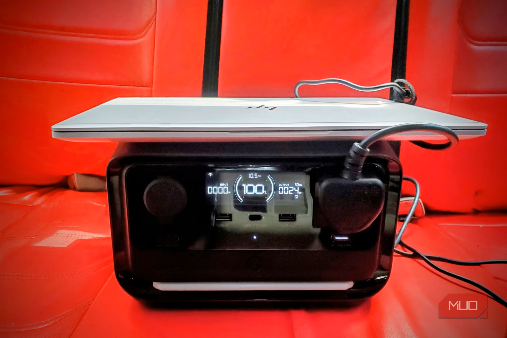 Charging a laptop with EcoFlow portable power station in the car.