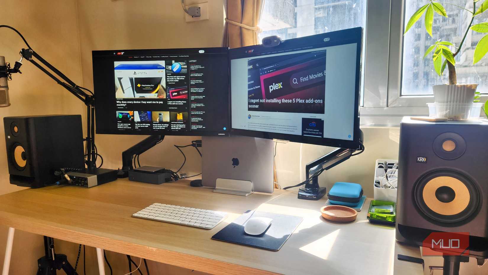 A desktop featuring dual monitors and wireless peripherals. 