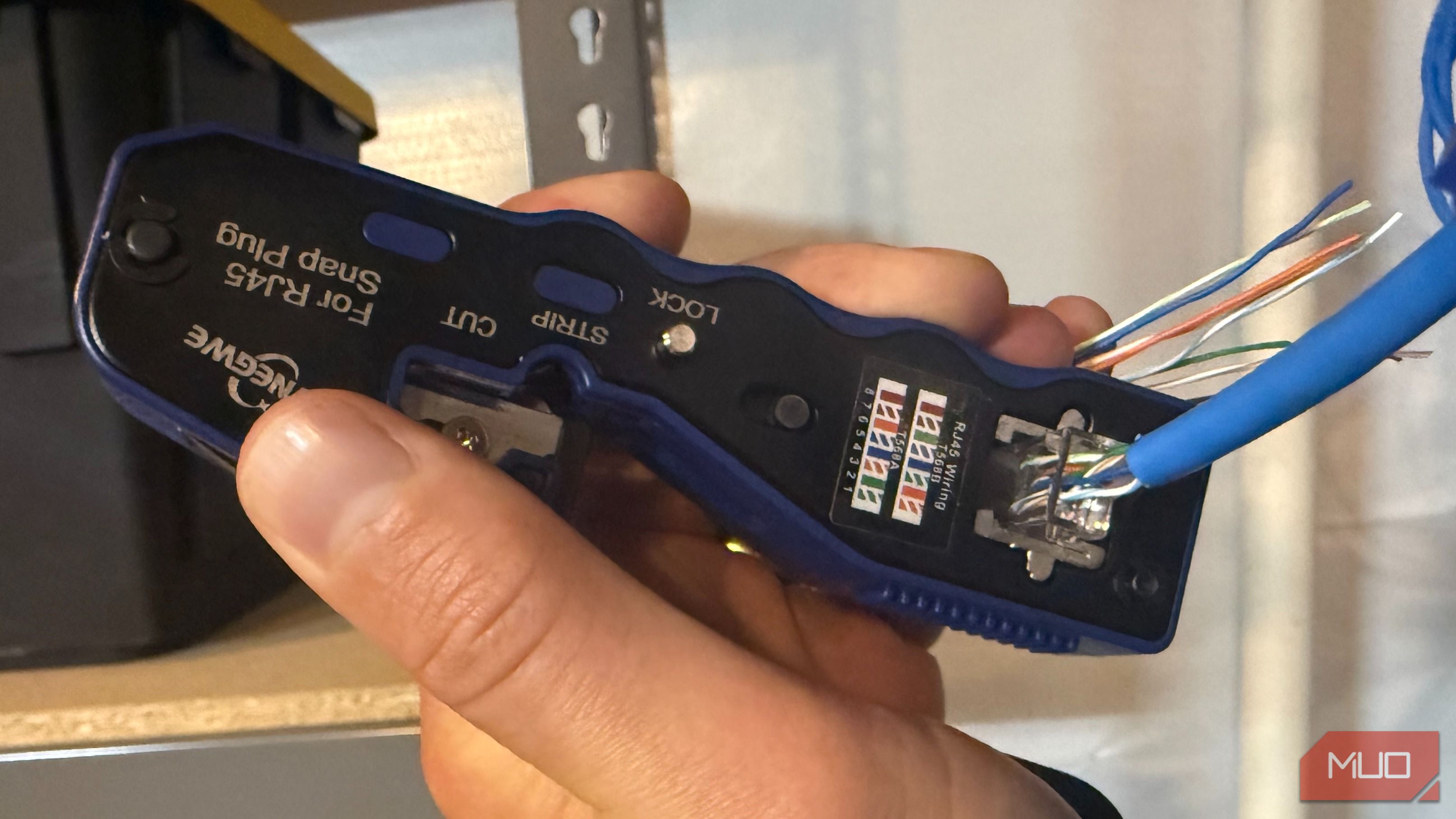 Crimping ethernet cable with crimp tool in hand