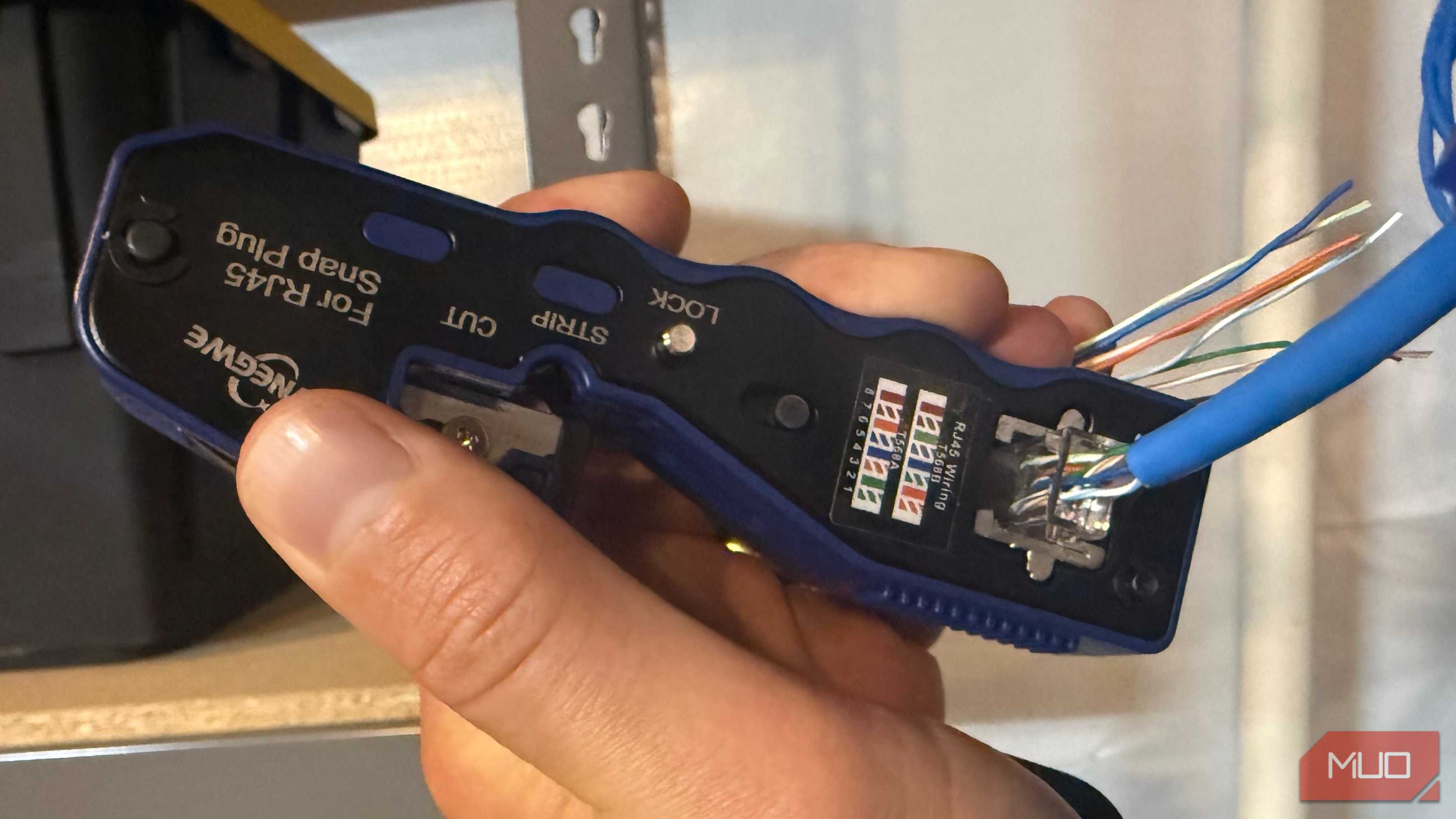 Crimping ethernet cable with crimp tool in hand