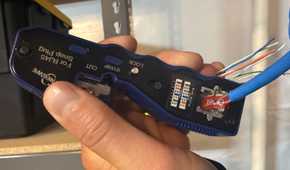 Crimping ethernet cable with crimp tool in hand