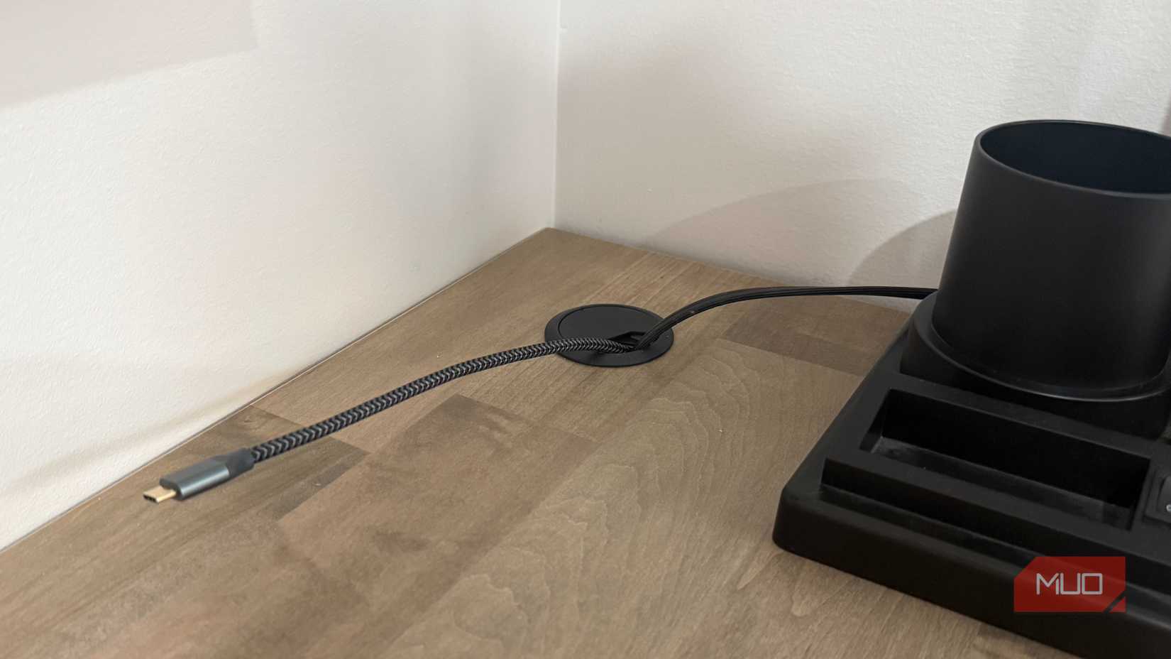 desk grommet with 2 cords near corner