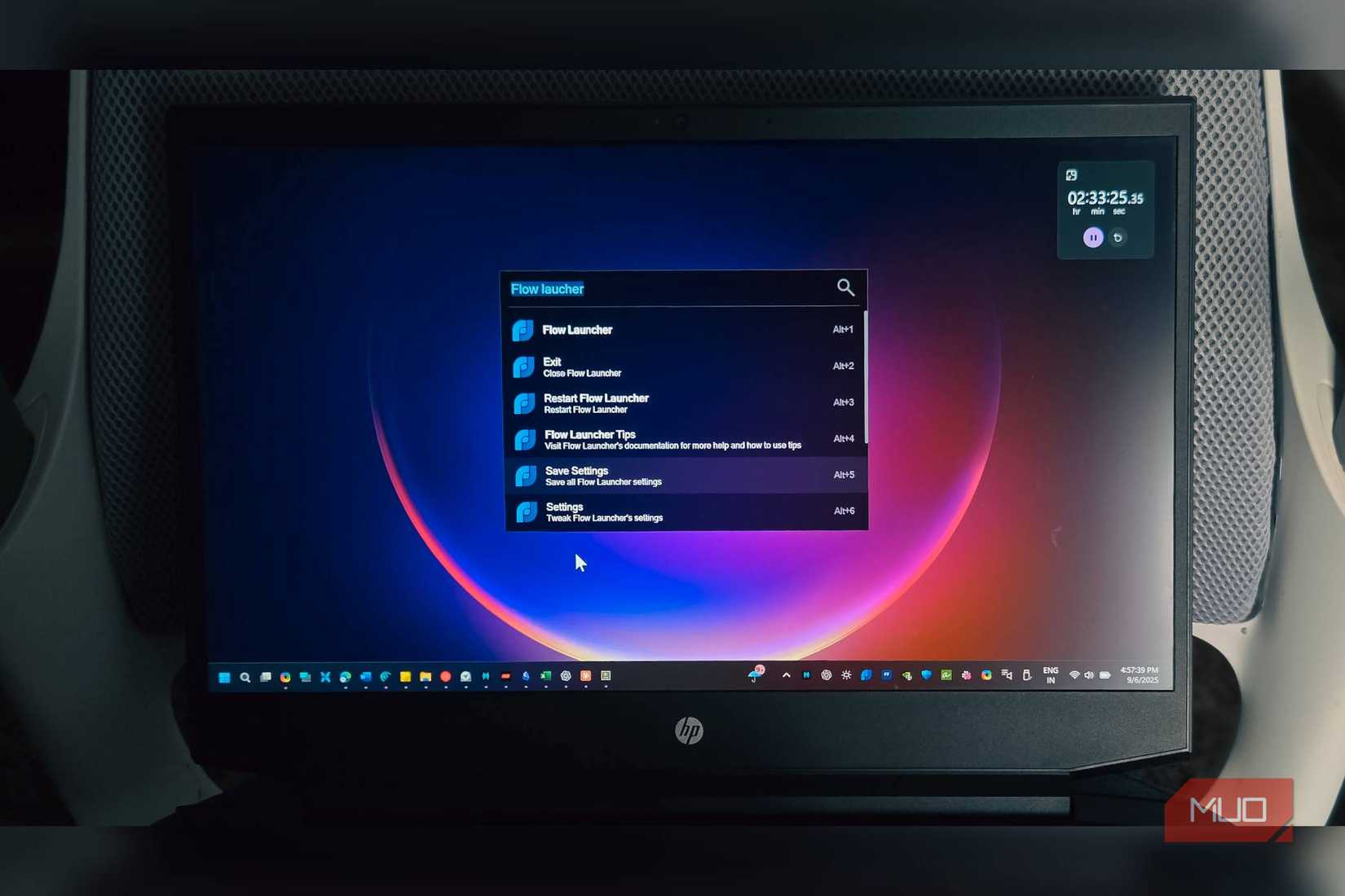 Flow Launcher search bar open on a HP Laptop kept on a chair
