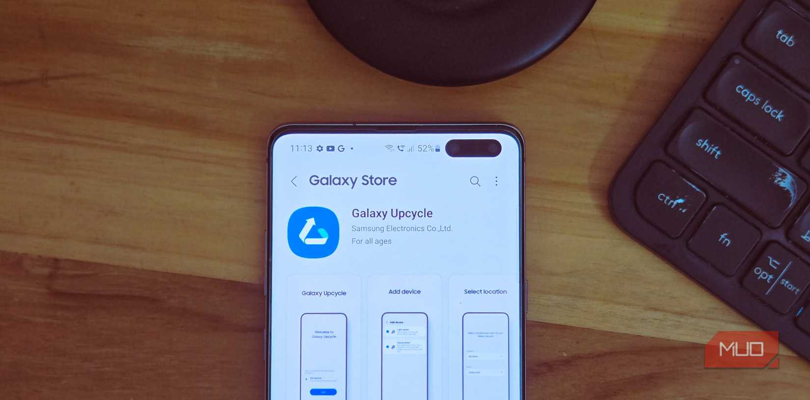Galaxy Store showing the Upcycle app on a Samsung S10 kept on a wooden table top 