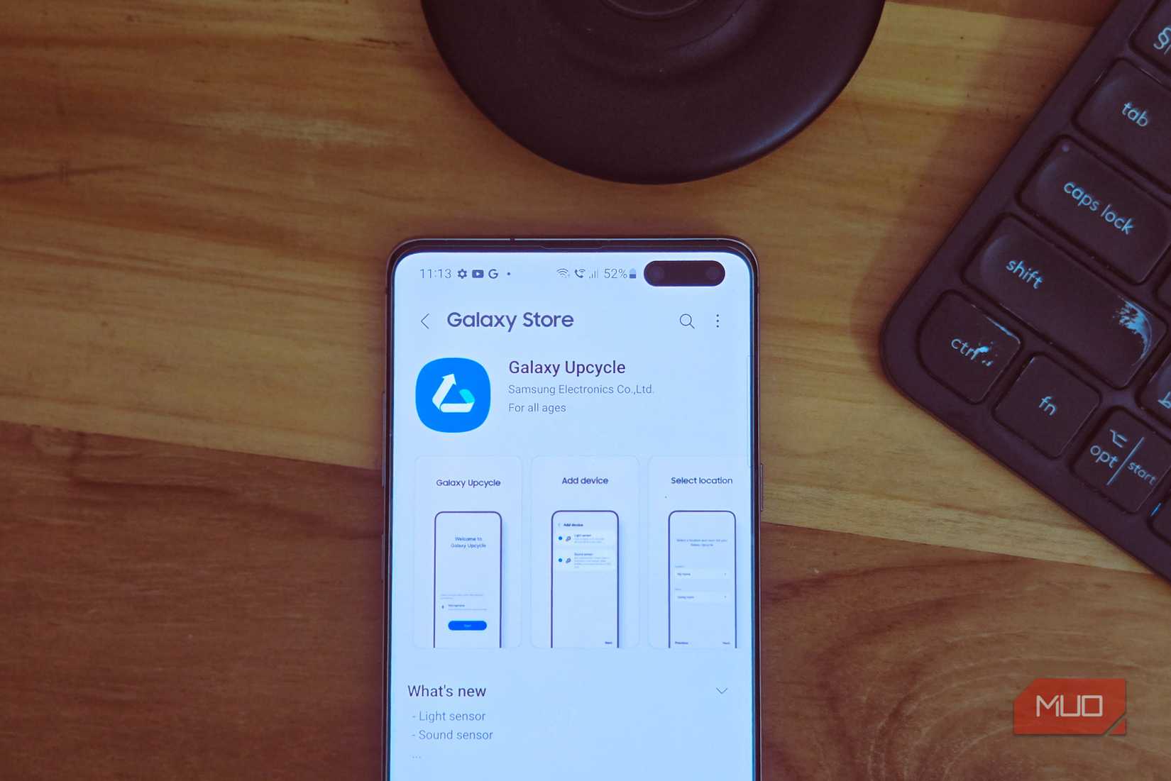 Galaxy Store showing the Upcycle app on a Samsung S10 kept on a wooden table top 