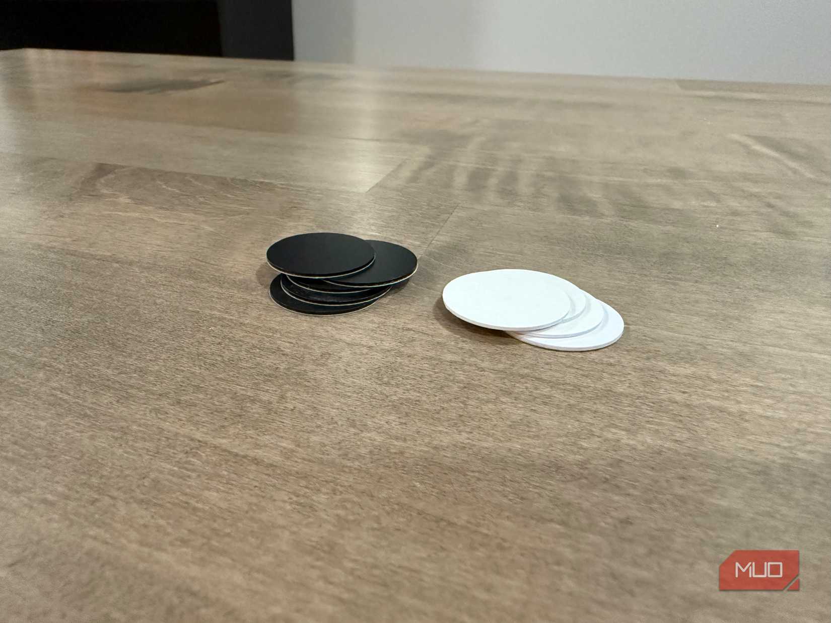 piles of white and black nfc tags on desk