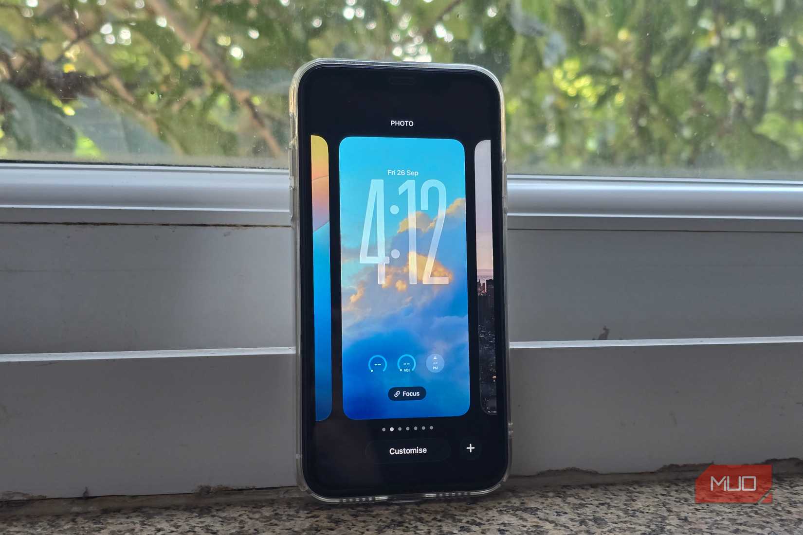 iOS 26 wallpaper switcher open on an iPhone