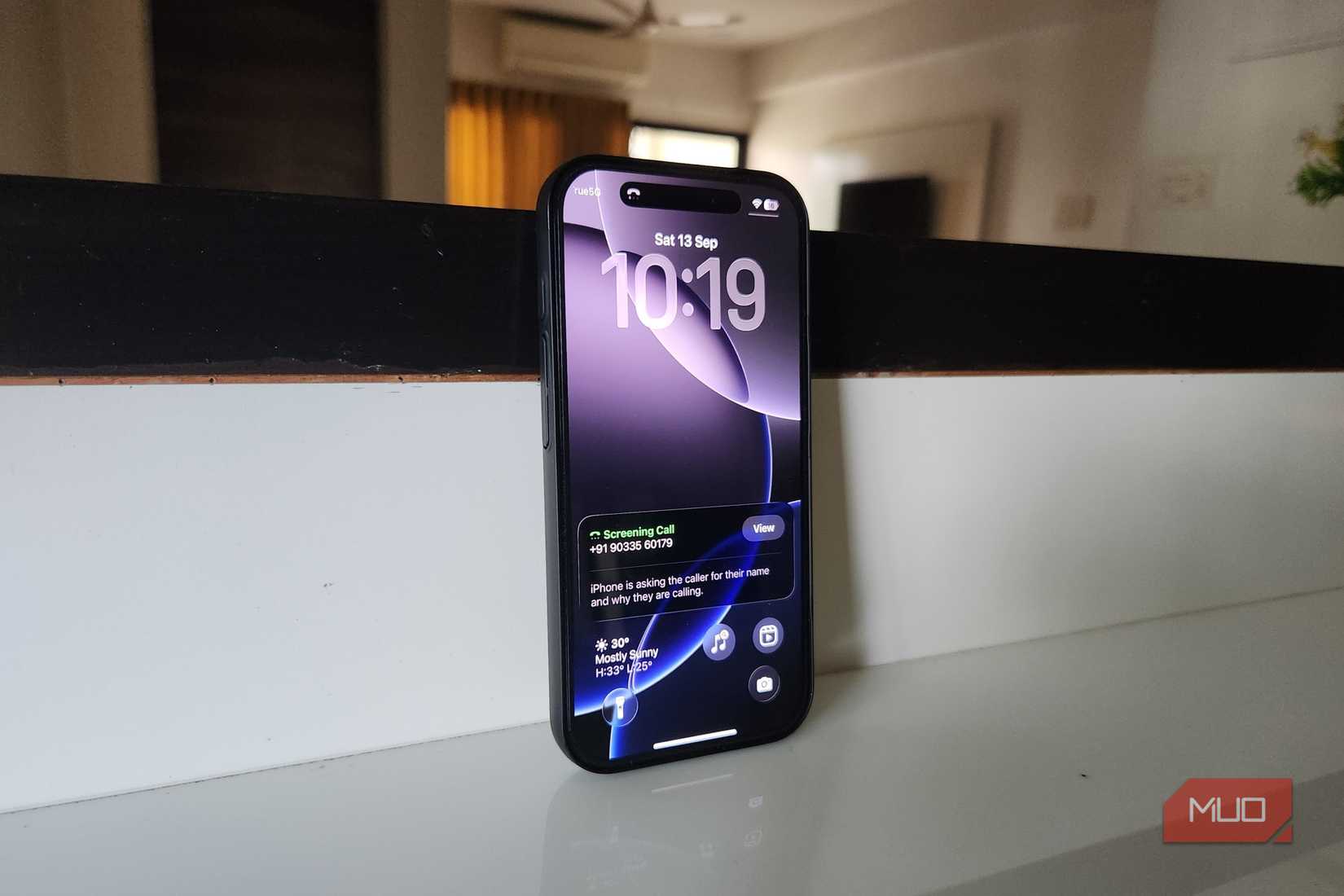 iPhone standing up right showing call screening feature of iOS 26