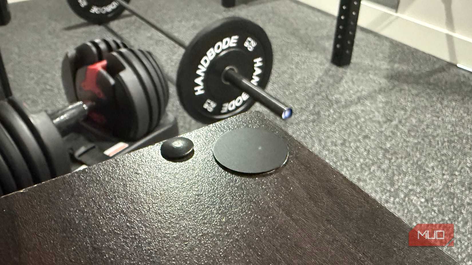 black nfc tag in home gym with weights in background