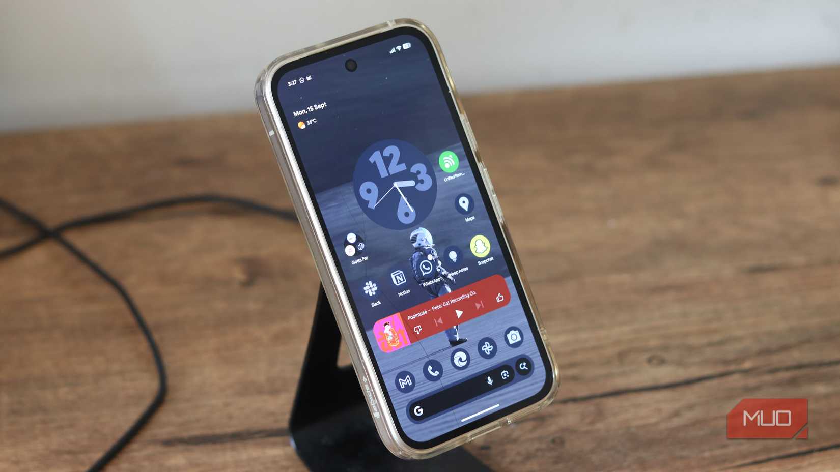 Pixel 9a on a wireless charging stand.